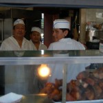 Workers behind food counter